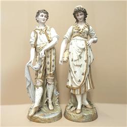 A pair of hand painted and enameled bisque