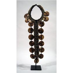 A FINE WEST PAPUAN BRIDAL ORNAMENT,