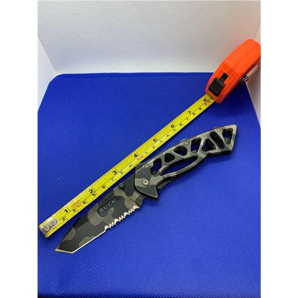 Buck folding pocket knife with clip.