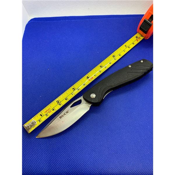 Buck folding pocket knife with clip.