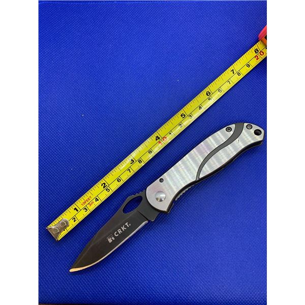 CRKT folding pocket knife with clip.