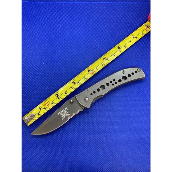 Schrade folding pocket knife with clip.