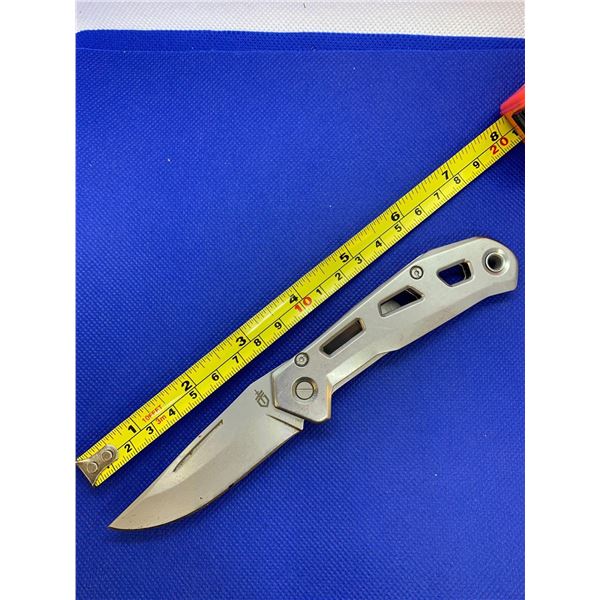 Gerber folding pocket knife with clip.