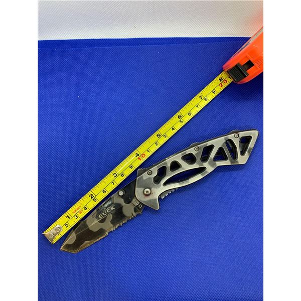 Buck folding pocket knife with clip.