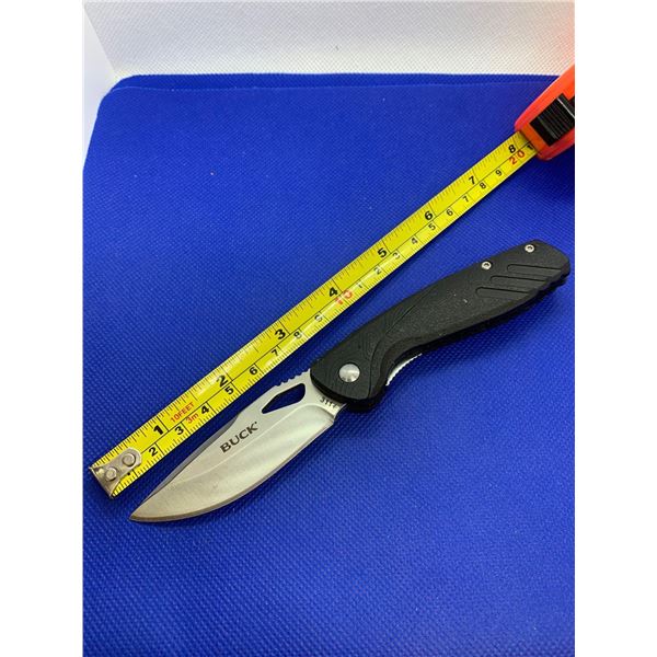 Buck folding pocket knife with clip.