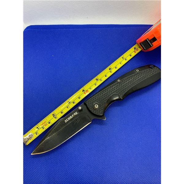 Schrade folding pocket knife with clip.