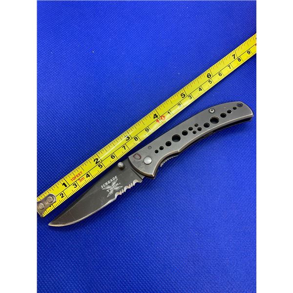 Schrade folding pocket knife with clip.