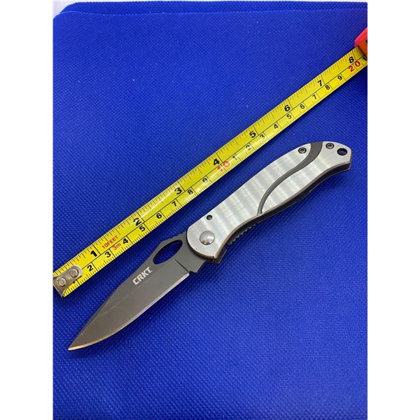 CRKT folding pocket knife with clip.