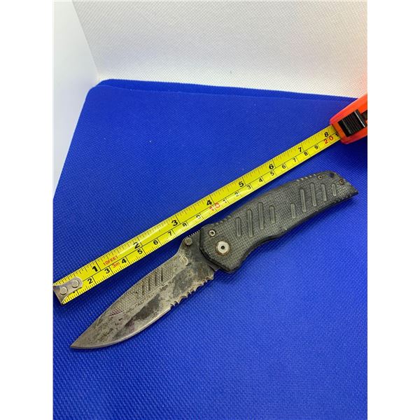 Gerber folding pocket knife with clip.