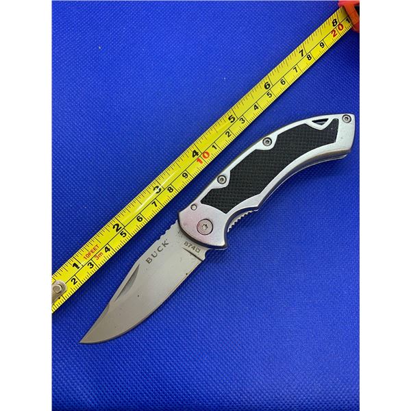 Buck folding pocket knife with clip.