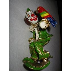 clown in sitting positing holding a red parrot!#1766682