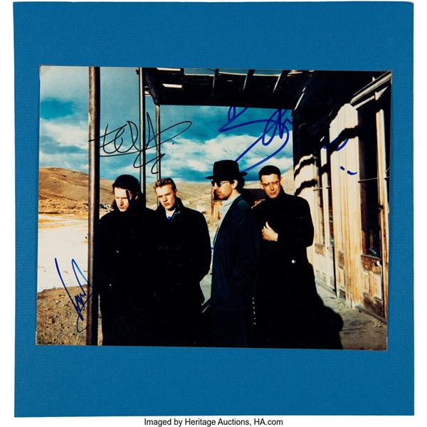 U2 Signed Promo Photo. Held in an 11 ½" x 11 ¾" display on thin blue cardboard,