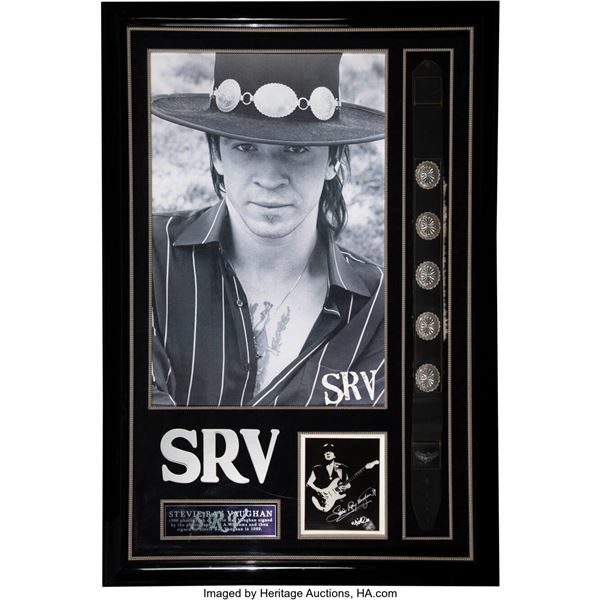 Stevie Ray Vaughan Signed Photo With Guitar Strap. Matted and framed to an amazi