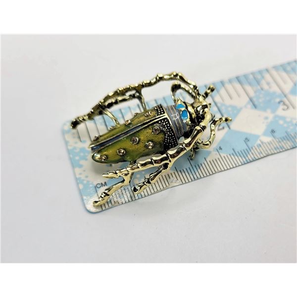 21)  GOLD TONE WITH CLEAR CRYSTAL AND BLUE &