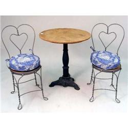 A CAST-IRON AND WOOD-TOP CIRCULAR TABLE