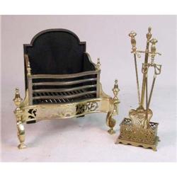 AN ORNATE 19TH CENTURY BRASS LOG HOLDER AND TWO FIRE TOOLS IN STAND