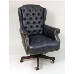 A BLUE LEATHERETTE SWIVELING CLUB CHAIR