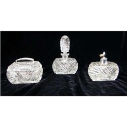 THREE COLORLESS GLASS DRESSER ARTICLES