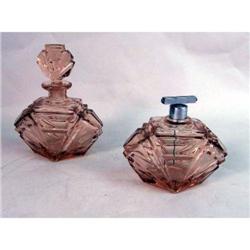 A ROSE COLORED GLASS PERFUME BOTTLE WITH STOPPER