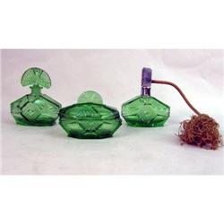 A GROUP OF EMERALD GREEN COLORED GLASS DRESSER ARTICLES