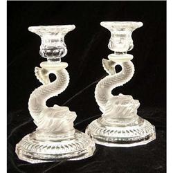 A PAIR OF NEOCLASSICAL STYLE FROSTED TO CLEAR GLASS DOLPHIN-FORM CANDLESTICKS