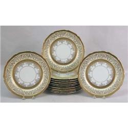 TWELVE PARCEL-GILT DECORATED PORCELAIN SHAPED SERVICE PLATES