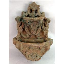 A SMALL CAST-STONE GARDEN ORNAMENT