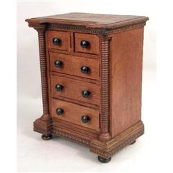 A MINIATURE CARVED WALNUT EMPIRE-STYLE CHEST OF DRAWERS WITH BUN FEET