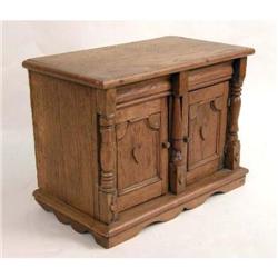 A CARVED MINIATURE CUPBOARD