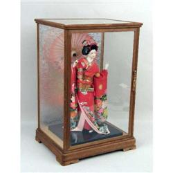 A PORCELAIN GEISHA DOLL