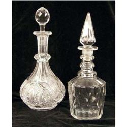 TWO COLORLESS GLASS STOPPERED DECANTERS