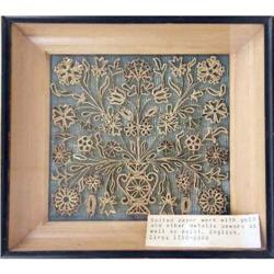 A FRAMED ROLLED PAPER WORK