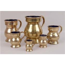 A GROUP OF SIX GRADUATED BRASS MEASURES