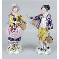 A PAIR OF CONTINENTAL POLYCHROME AND PARCEL GILT PORCELAIN FIGURES
