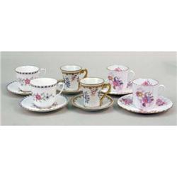 A MISCELLANEOUS GROUP OF POLYCHROME AND PARCEL-GILT DECORATED PORCELAIN DEMI-TASSE CUPS AND SAUCERS