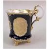 Image 2 : A COBALT PARCEL-GILT DECORATED PORCELAIN FOOTED HANDLED CUP