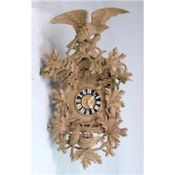 A LARGE CARVED MAPLE CUCKOO CLOCK