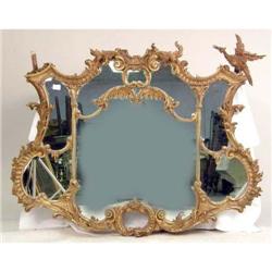 A LARGE CARVED AND GESSOED CHIPPENDALE STYLE WALL MIRROR