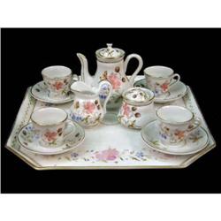 AN ASSEMBLED POLYCHROME DECORATED PORCELAIN CHILDREN`S TEA SERVICE