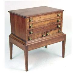 A SMALL CHEST OF DRAWERS