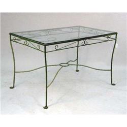A GREEN-PAINTED METAL AND GLASS-TOPPED KITCHEN/GARDEN TABLE. 30" h x 48" l x 30 1/4" d.