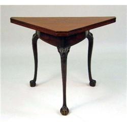 A CHIPPENDALE-STYLE CARVED MAHOGANY HANDKERCHIEF-FORM GAMES TABLE