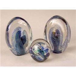 A GROUP OF THREE COLORLESS AND IRIDESCENT PAPERWEIGHTS