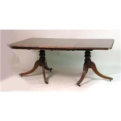 A REGENCY-STYLE MAHOGANY TWO-PEDESTAL DINING TABLE