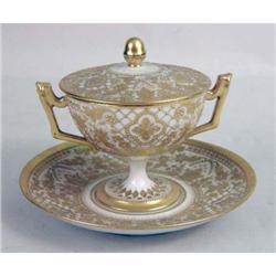 A PARCEL-GILT DECORATED PORCELAIN DOUBLE HANDLED COMPOTE WITH UNDERPLATE