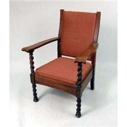 A QUARTER-SAWN OAK UPHOLSTERED ARMCHAIR