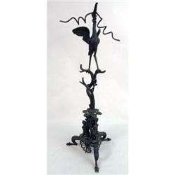 A CAST BRONZE SCULPTURE OF A CRANE IN COMBAT WITH A SNAKE