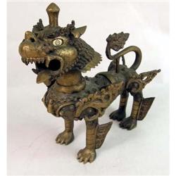 A GILT-BRONZE NEPALESE TEMPLE GUARDIAN IN THE AVATAR OF A FIERCE WINGED DOG