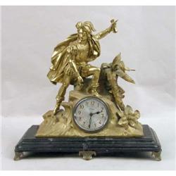 A GILT METAL FIGURAL MANTLE CLOCK