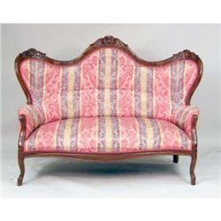 A CARVED ROSEWOOD SERPENTINE-BACK VICTORIAN-STYLE SOFA
